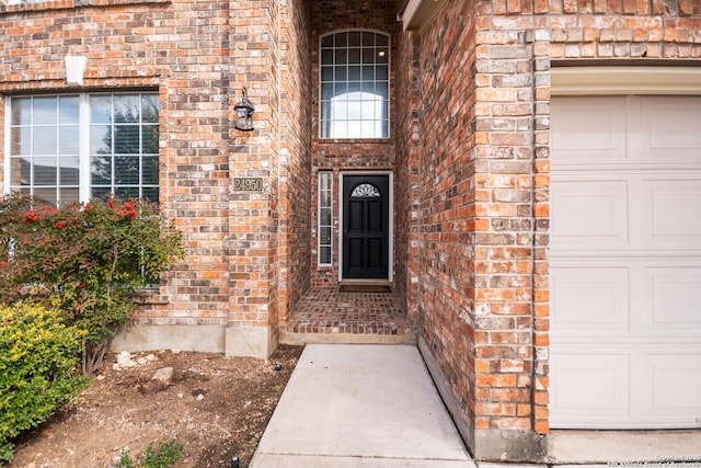 view of exterior entry with a garage