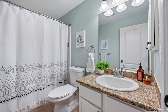 bathroom featuring tile patterned floors, vanity, and toilet