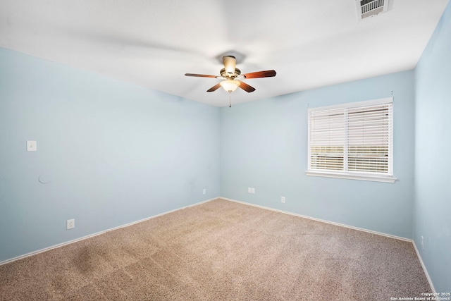 spare room featuring carpet floors and ceiling fan