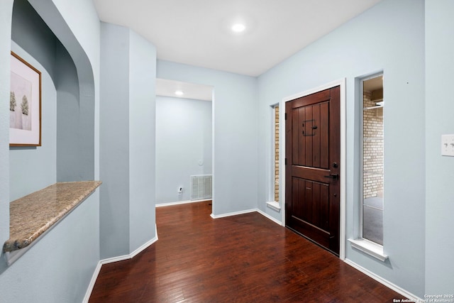 foyer entrance with dark hardwood / wood-style floors