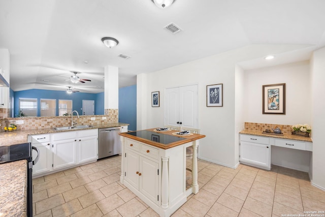 kitchen with sink, white cabinetry, built in desk, dishwasher, and decorative backsplash