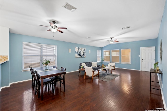 dining space featuring ceiling fan, dark hardwood / wood-style floors, and vaulted ceiling