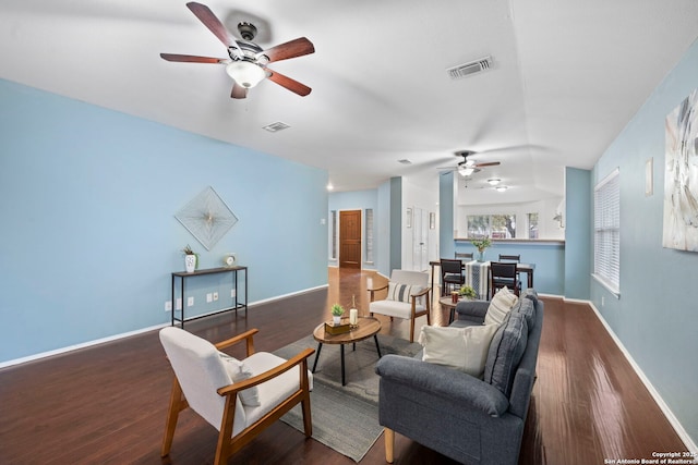 living room with ceiling fan and dark hardwood / wood-style flooring