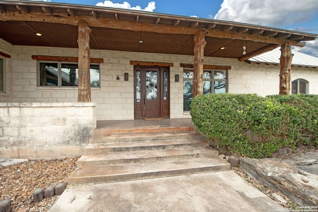 doorway to property featuring covered porch