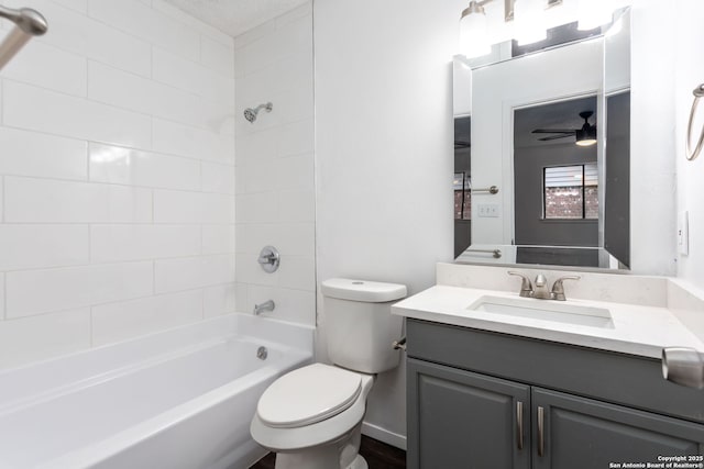 full bathroom with vanity, bathtub / shower combination, ceiling fan, and toilet