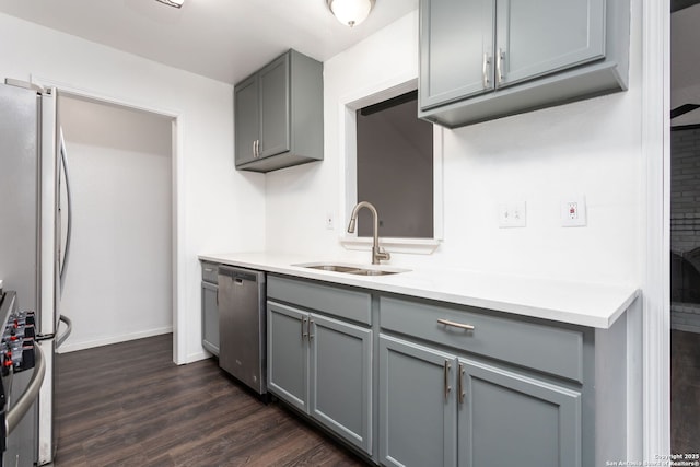 kitchen with sink, gray cabinets, stainless steel appliances, and dark hardwood / wood-style floors