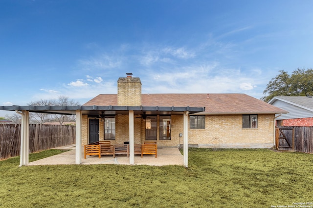 rear view of house with a patio area and a lawn