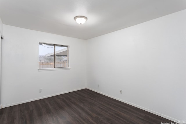 spare room with dark wood-type flooring