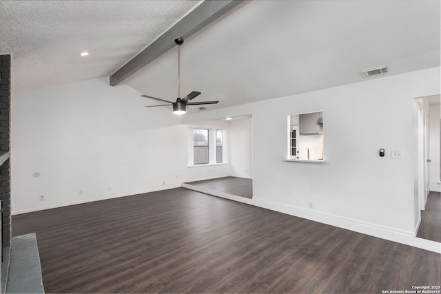 unfurnished living room with ceiling fan, lofted ceiling with beams, a textured ceiling, dark hardwood / wood-style flooring, and a brick fireplace