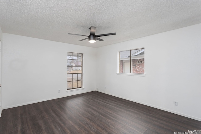 spare room featuring ceiling fan, dark hardwood / wood-style floors, and a textured ceiling