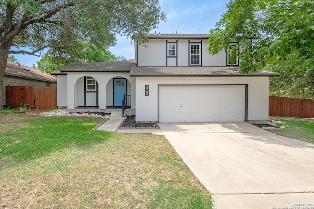 view of front of house with a garage and a front yard