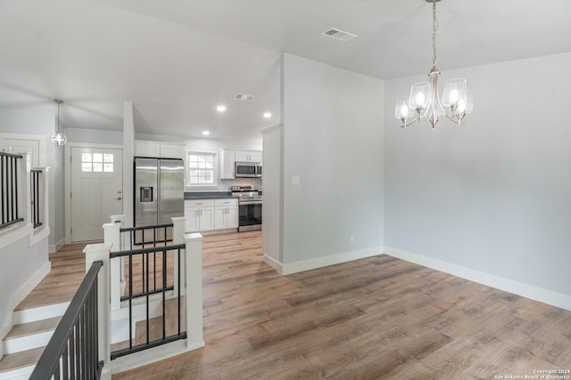 dining area with a chandelier and light hardwood / wood-style flooring