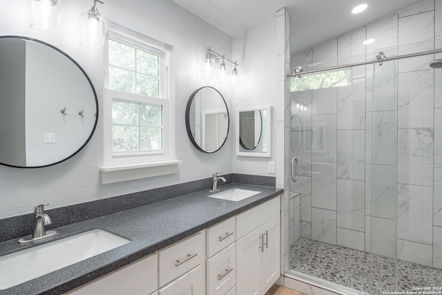 bathroom with vanity and a shower with shower door