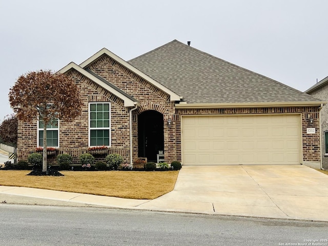 view of front of home featuring a garage and a front lawn