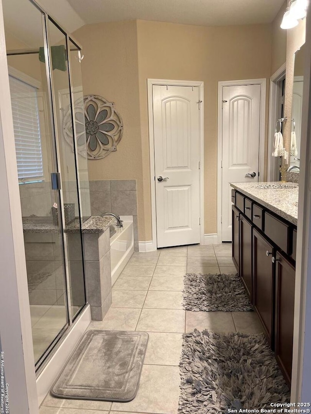 bathroom with vanity, shower with separate bathtub, and tile patterned floors