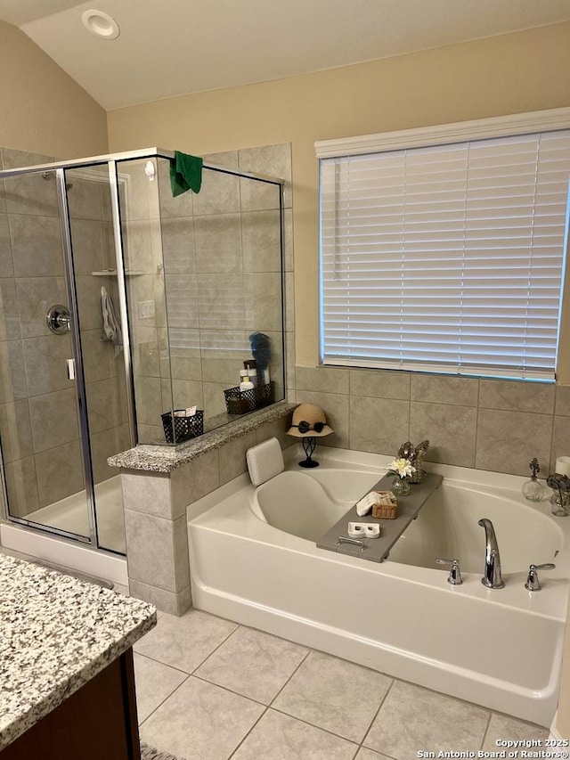 bathroom with vanity, tile patterned floors, shower with separate bathtub, and lofted ceiling