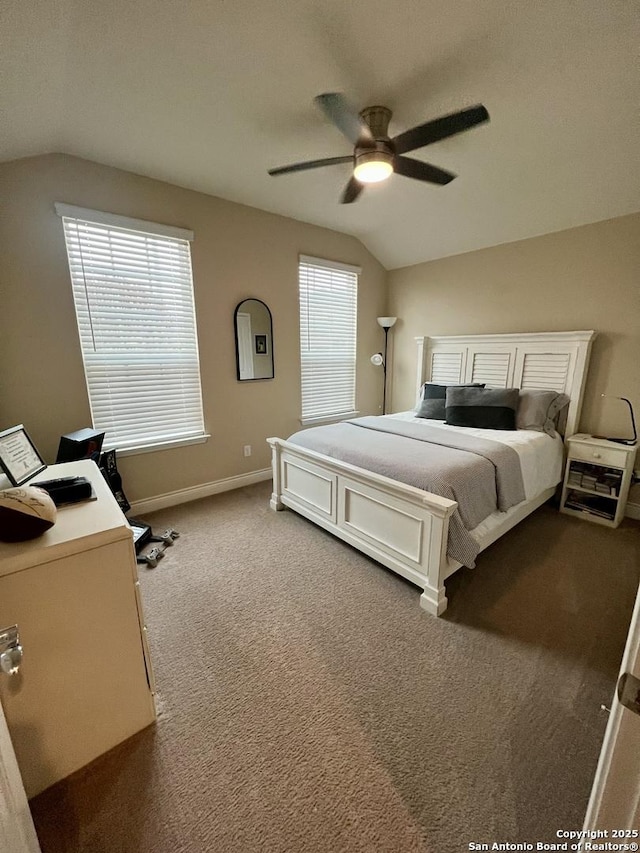 bedroom featuring lofted ceiling, carpet floors, multiple windows, and ceiling fan