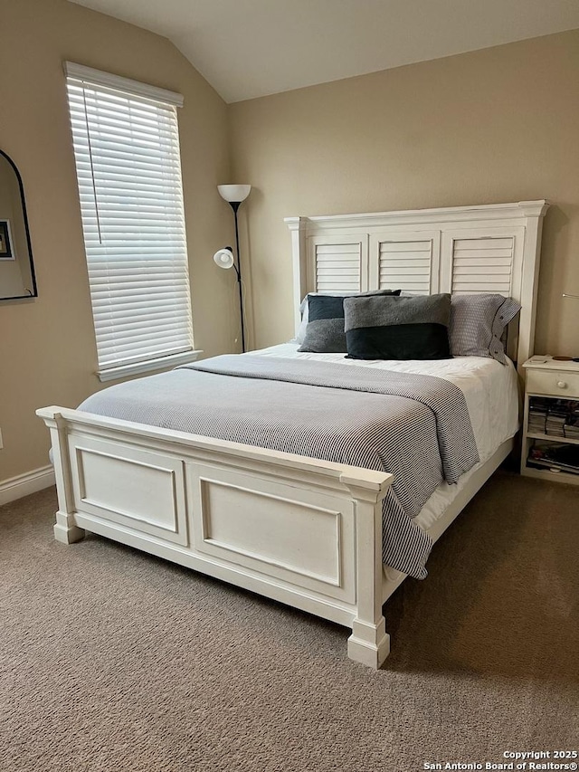 carpeted bedroom featuring lofted ceiling