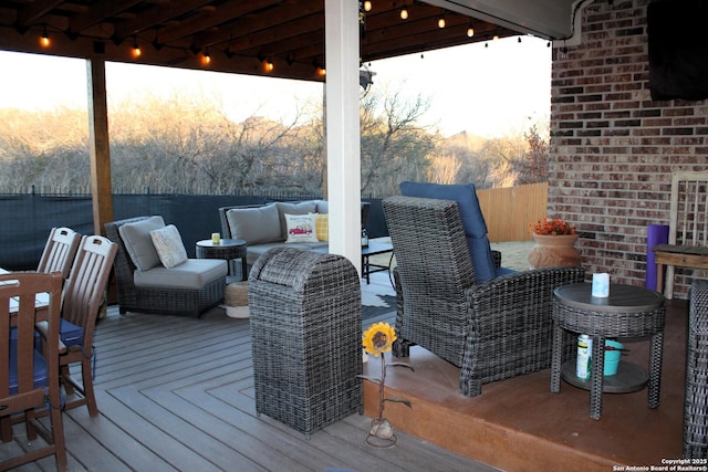 deck at dusk featuring an outdoor living space