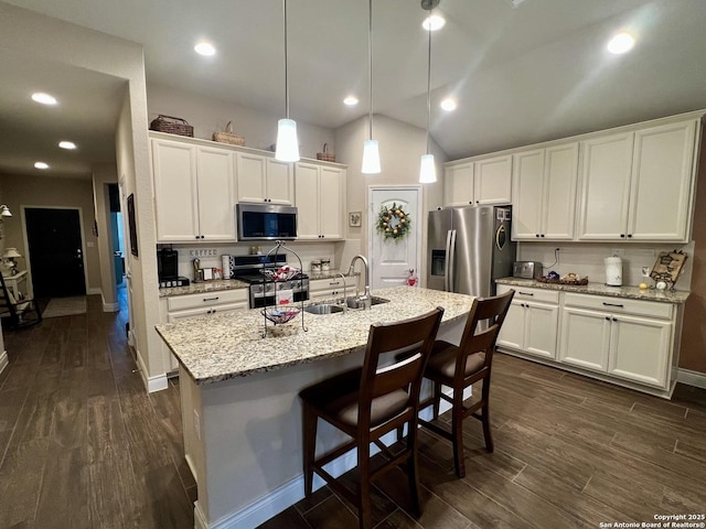 kitchen with sink, white cabinetry, an island with sink, pendant lighting, and stainless steel appliances