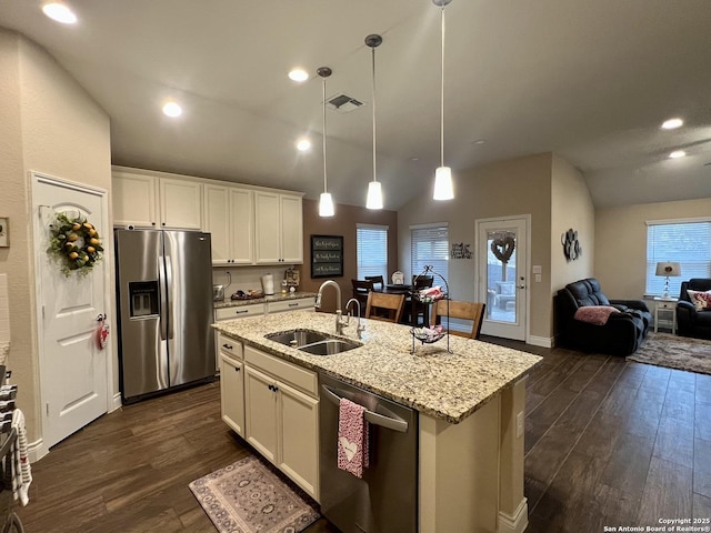 kitchen featuring a kitchen island with sink, sink, white cabinets, and appliances with stainless steel finishes