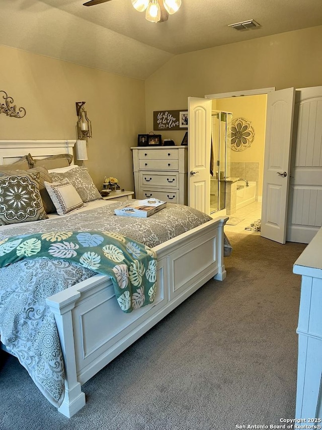 bedroom featuring lofted ceiling, carpet floors, ceiling fan, and ensuite bath