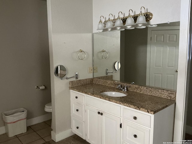 bathroom featuring vanity, tile patterned floors, and toilet