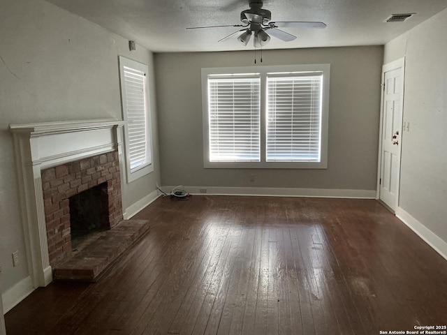 unfurnished living room featuring dark wood-type flooring, ceiling fan, and a fireplace