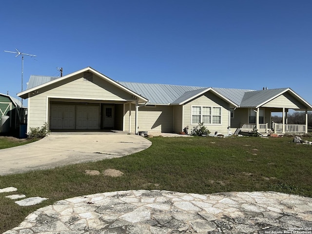 ranch-style house with a porch, a garage, and a front lawn