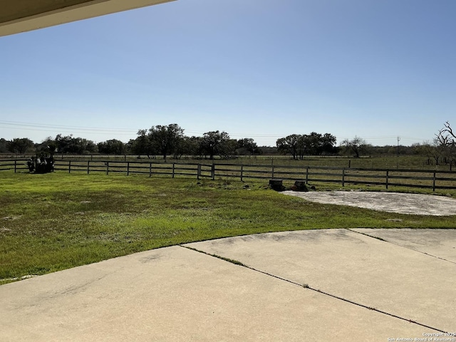 view of yard featuring a rural view and a patio