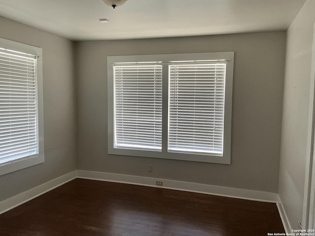 unfurnished room featuring dark wood-type flooring