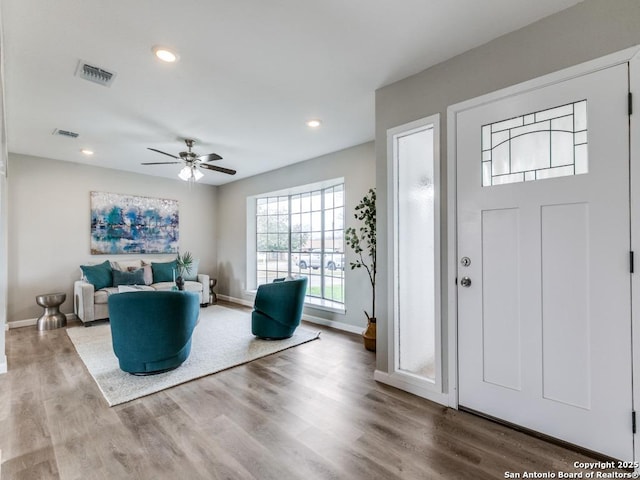 foyer entrance with hardwood / wood-style flooring and ceiling fan