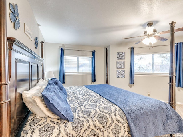 carpeted bedroom with a textured ceiling and ceiling fan