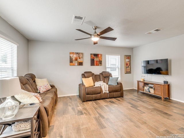 living room with ceiling fan and wood-type flooring