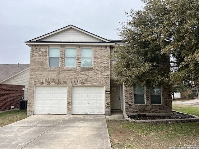 view of front of property featuring central AC unit and a garage