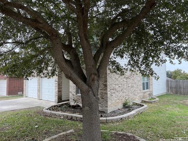 view of property exterior with a garage and a lawn