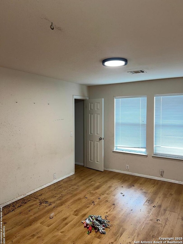 unfurnished room with light wood-type flooring