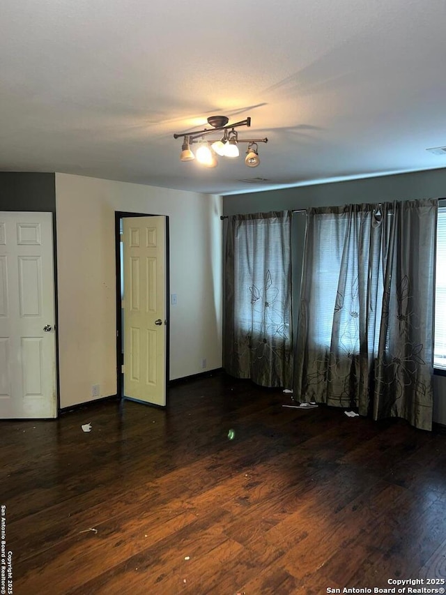 empty room with dark wood-type flooring