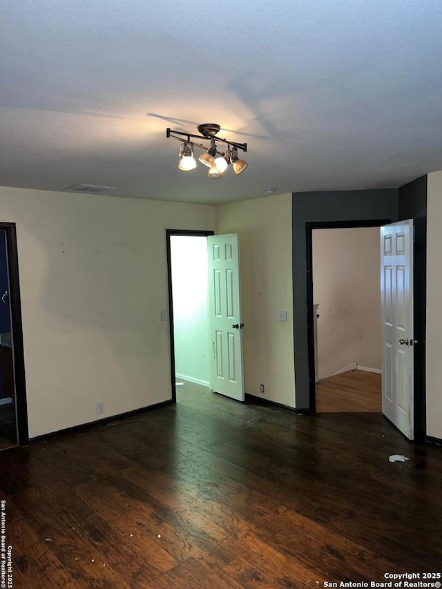 spare room featuring dark wood-type flooring