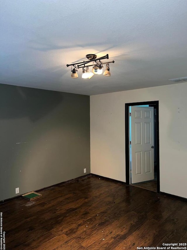 empty room with dark wood-type flooring