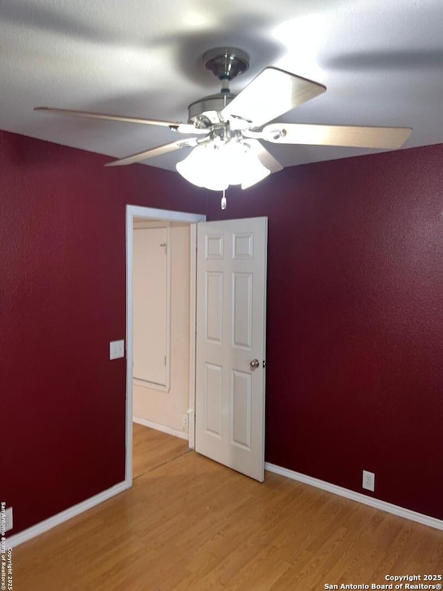 unfurnished bedroom featuring ceiling fan and light wood-type flooring