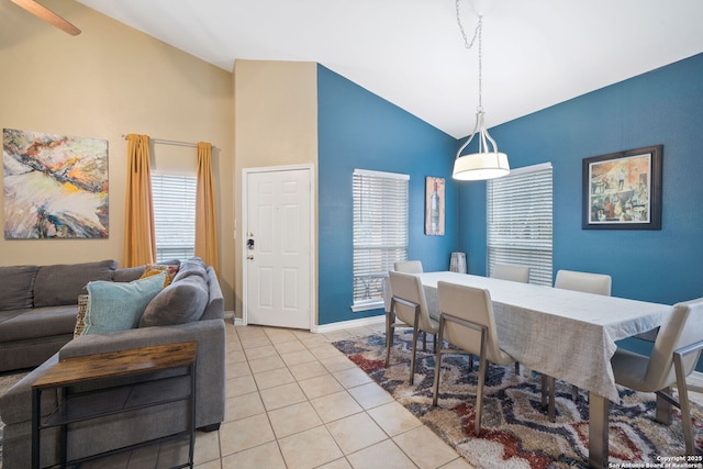 dining space featuring vaulted ceiling and light tile patterned flooring