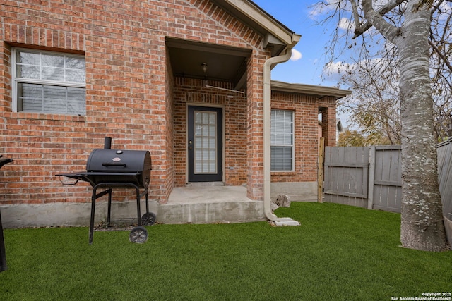 entrance to property featuring a yard