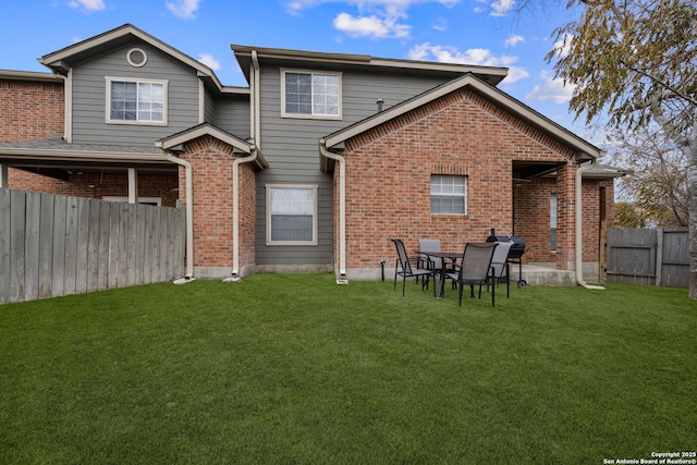 rear view of house with a patio area and a lawn