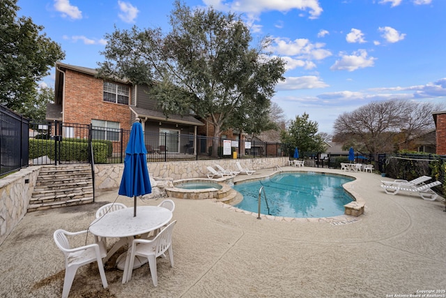 view of pool with a patio area and a community hot tub