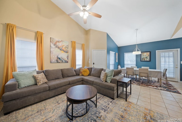 tiled living room featuring ceiling fan and high vaulted ceiling