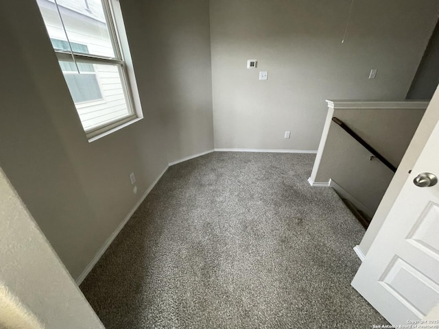 spare room featuring dark carpet