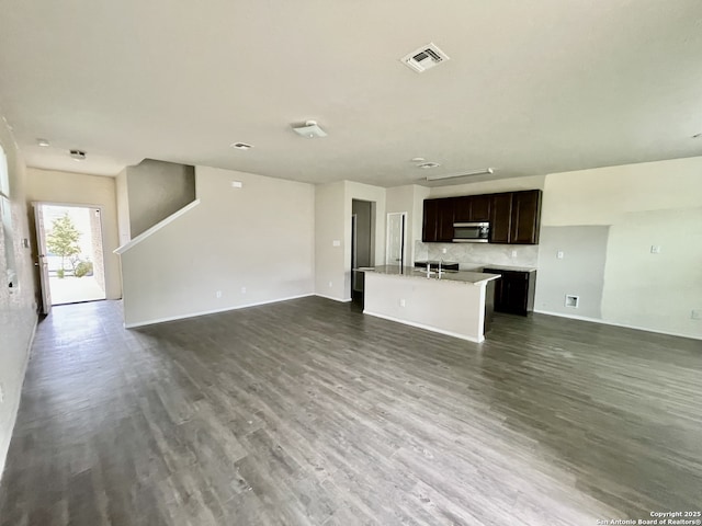 unfurnished living room with dark hardwood / wood-style floors