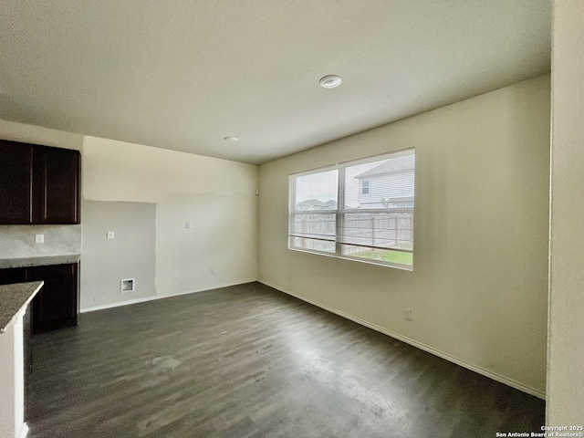 interior space with dark brown cabinetry, tasteful backsplash, and dark hardwood / wood-style floors