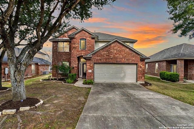 front facade with a garage and a lawn